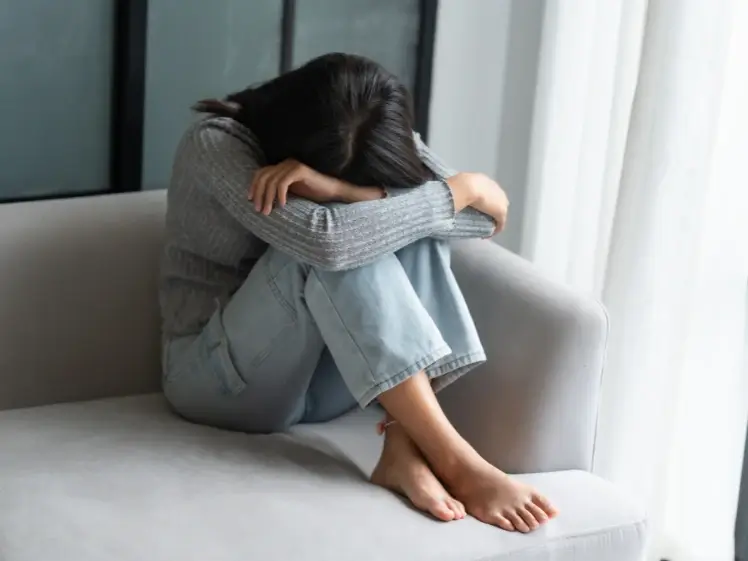 Person holding in emotions alone reflecting the impact of emotional suppression