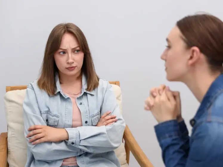 Friends having a tense conversation showing the risks of venting to the wrong person