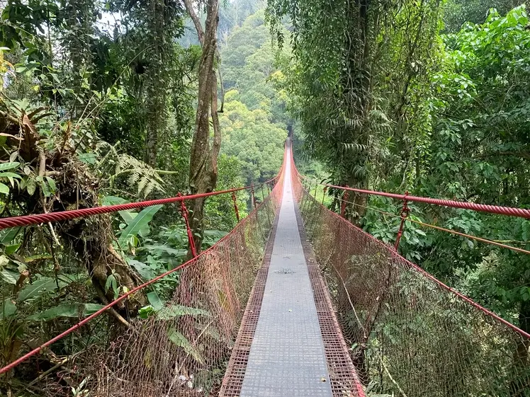 Jembatan Merah surrounded by natural scenery in Situ Gunung, Sukabumi